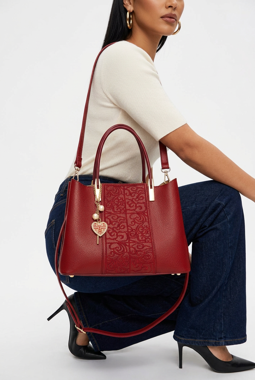 Gros plan du sac rouge embossé à poignée porté